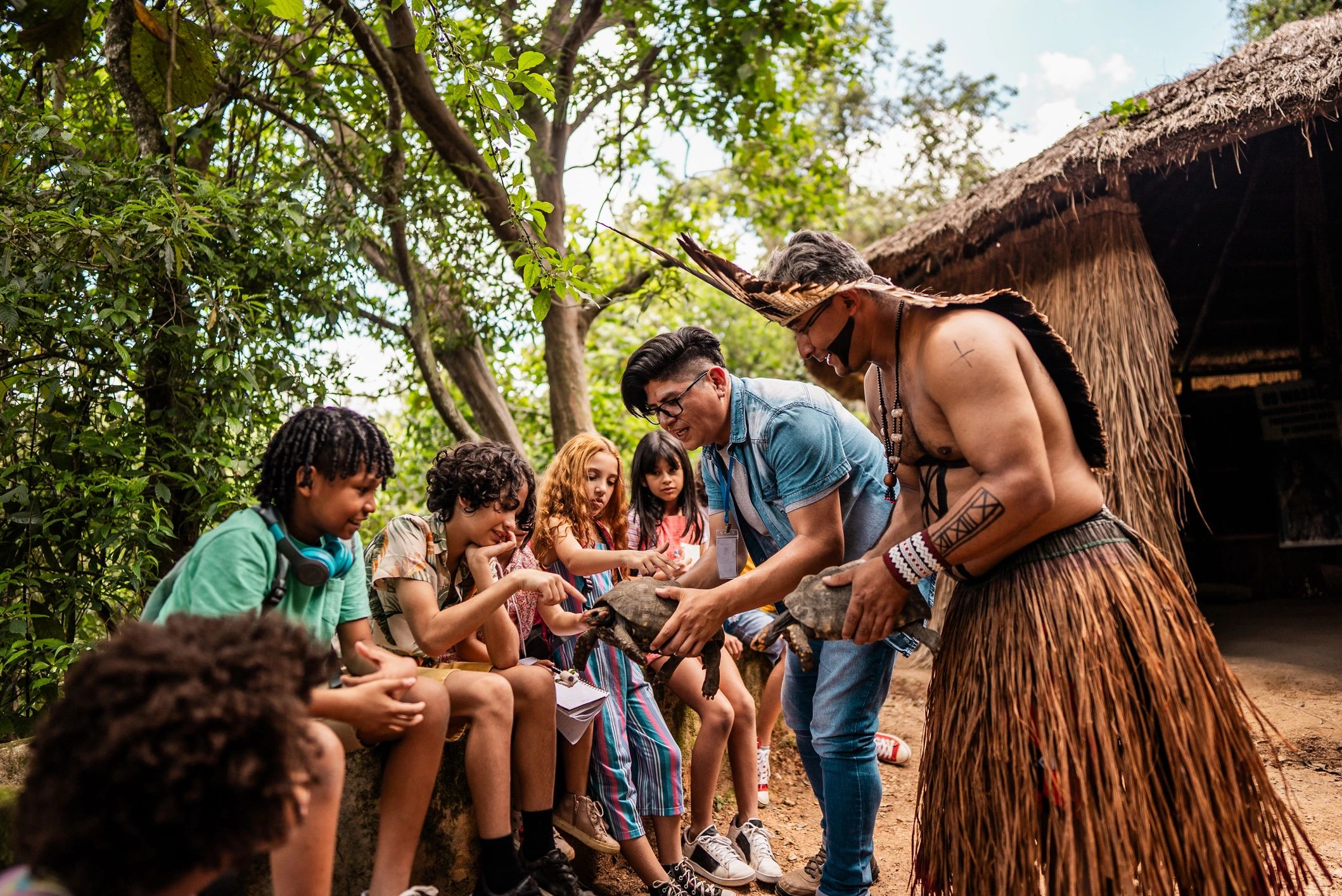 Children and community members sharing a cultural learning moment